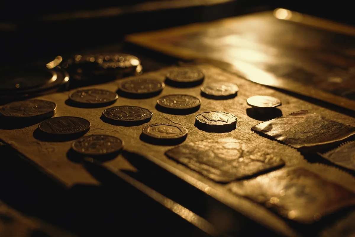 Close-up of antique coins on a table, highlighting their rich textures and details relevant to selling coins.