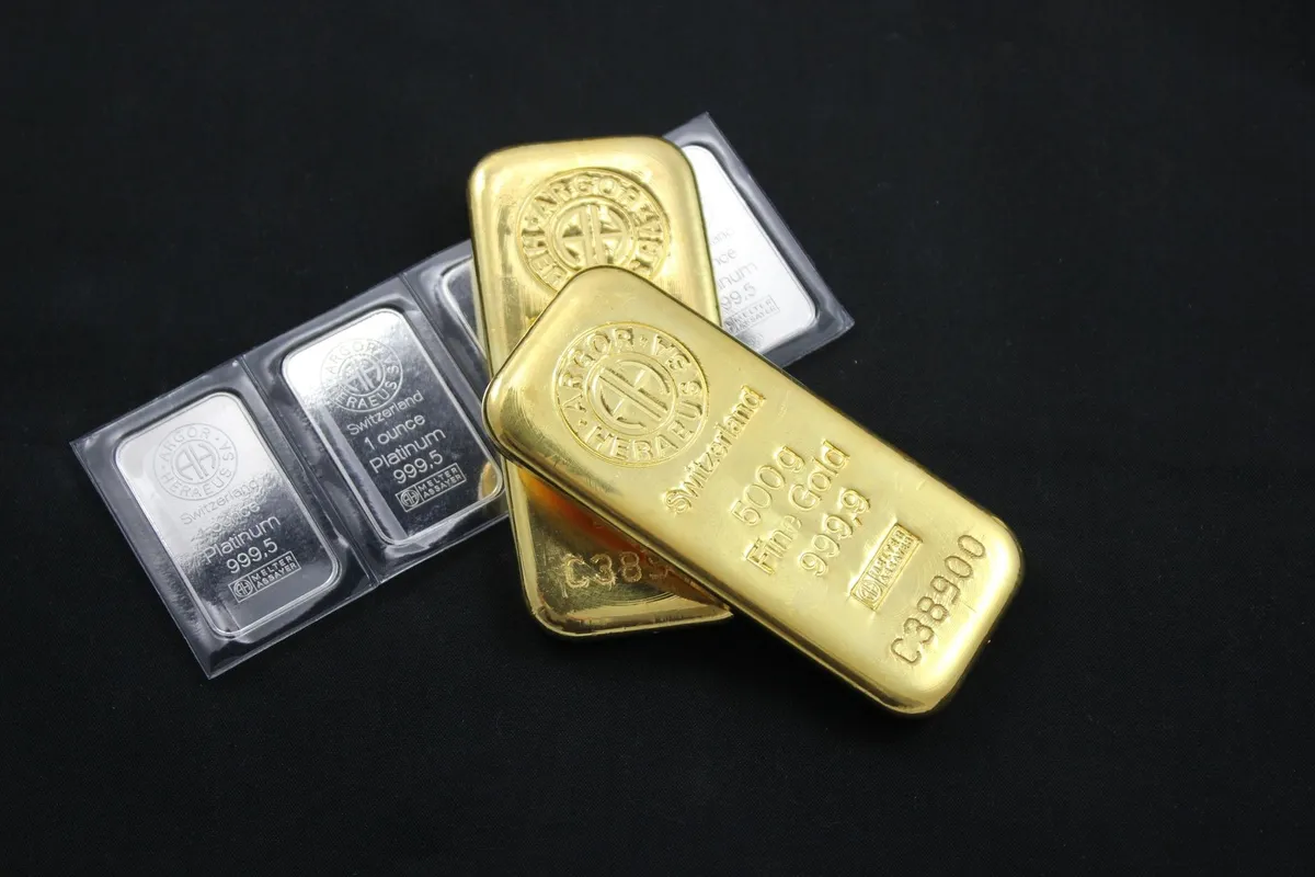 Close-up of gold and platinum bars highlighting their value as investments in precious metals.