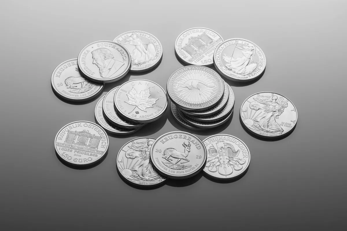 Close-up of shiny silver bullion coins with detailed designs, reflecting the interest of buyers.